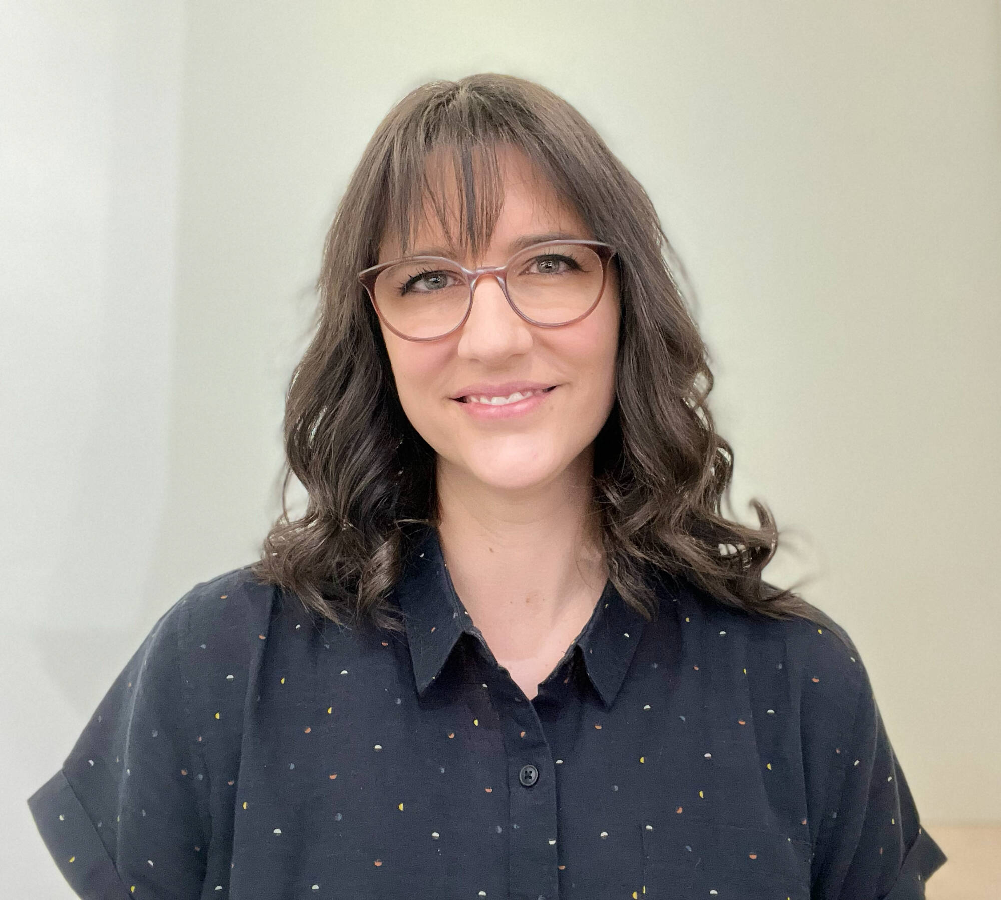 a dark haired woman with glasses